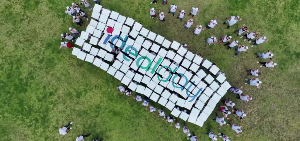Crowd holding boards spelling IdealDay